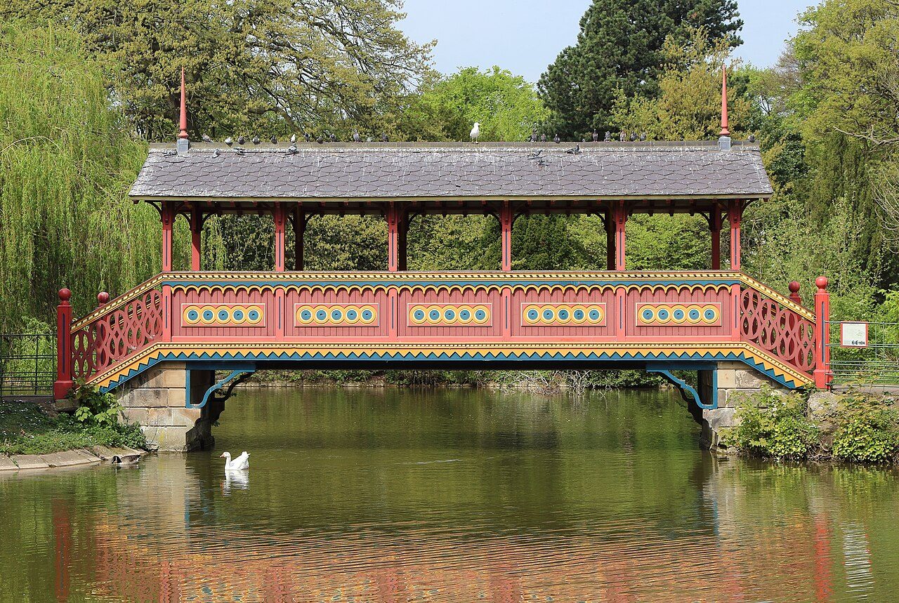 The red Swiss Bridge over the lake in Birkenhead Park