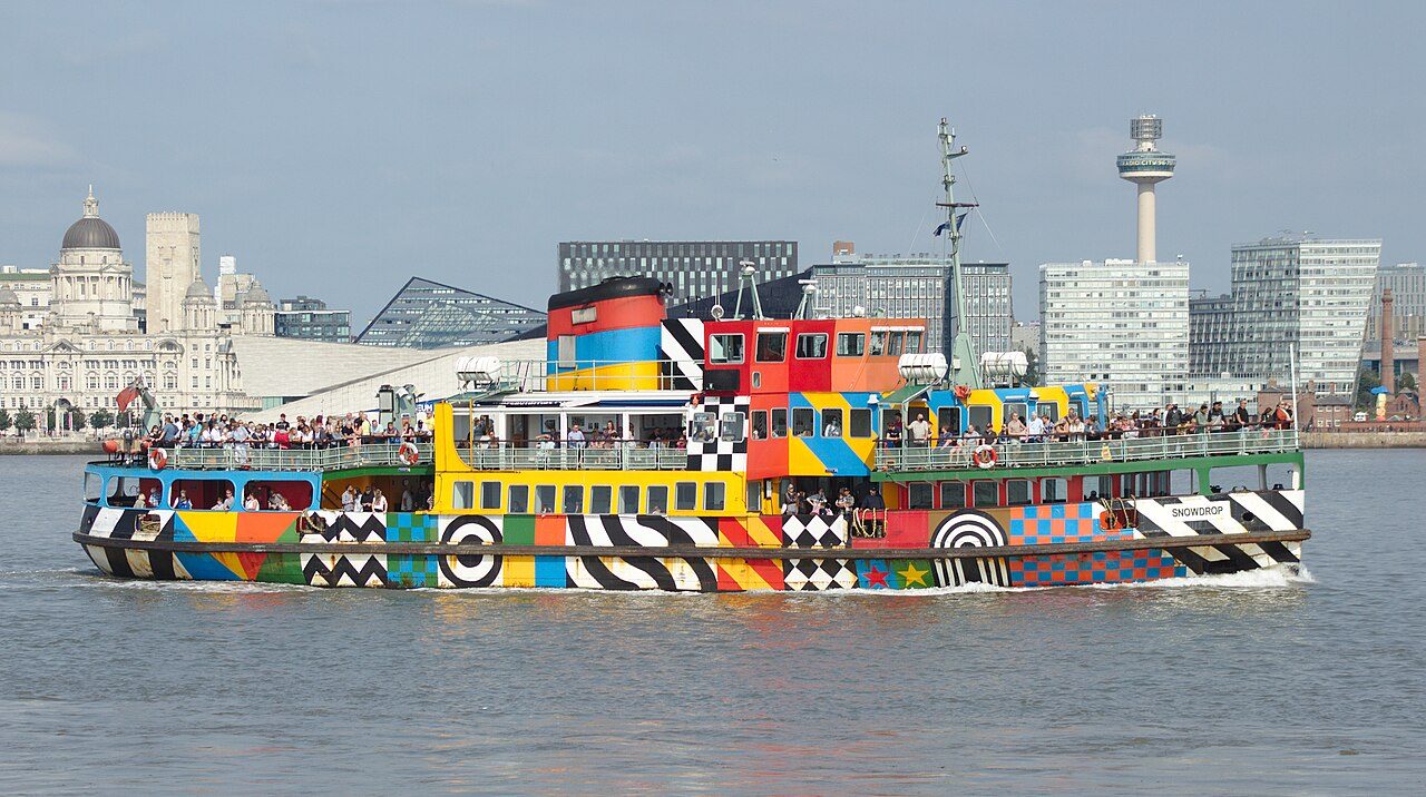 The Mersey Ferry Snowdrop in its dazzle paint on the river, with the Liverpool waterfront behind