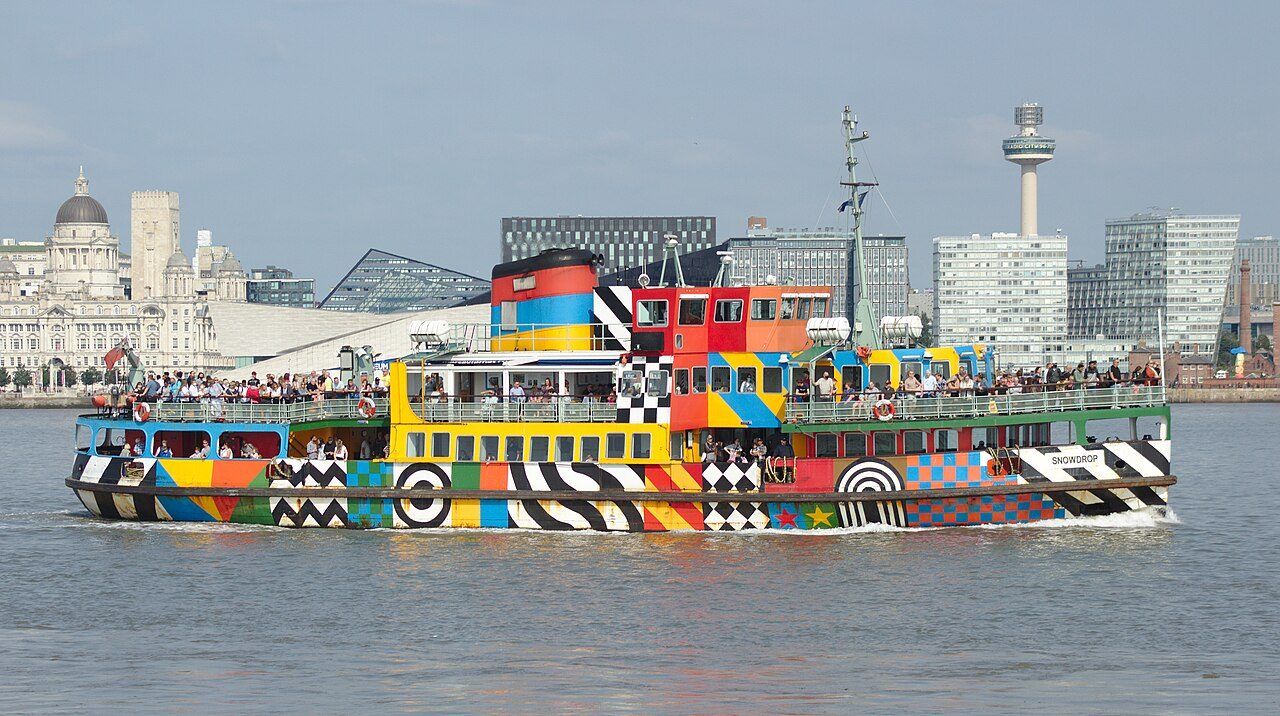 The Mersey Ferry Snowdrop in its dazzle paint on the river, with the Liverpool waterfront behind